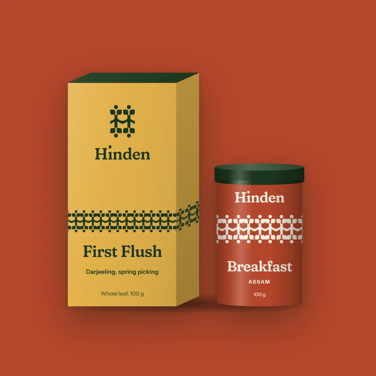 Hinden's gift box and a tin standing front on against Breakfast copper, a contact shadow under them
